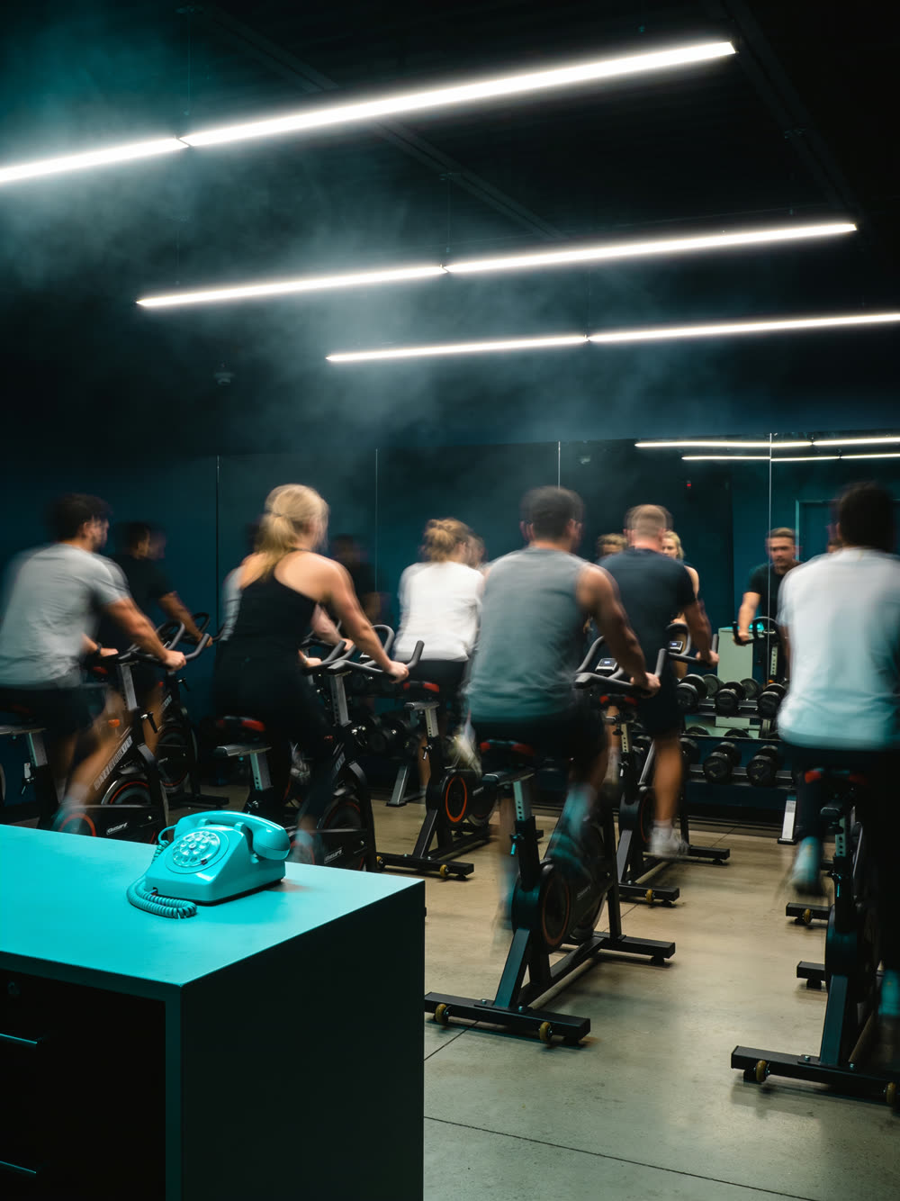 A boutique fitness studio mid-session, every station full while the front desk sits empty